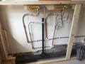 Showing the in-progress piping for a new bathroom basin which will be elevated above a small cupboard unit.