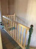 A bespoke balustrade and handrail at the top of a set of stairs