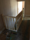 A bespoke balustrade and handrail at the top of a set of stairs